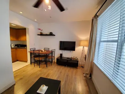a living room with a table and a television at 1 Bed on Collins Av close to Beach in Miami Beach