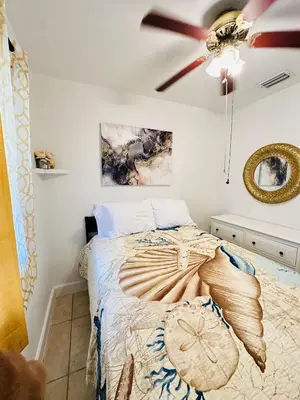 a bedroom with a bed and a ceiling fan at Miami Casa II in Miami Gardens