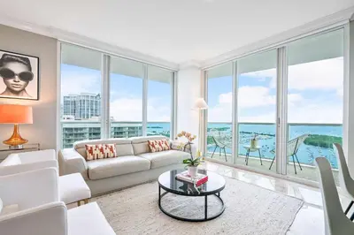 a living room with a white couch and large windows at MVR - Where Families and Professionals Align in Miami
