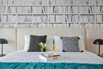 a bedroom with a bed with a tray of food and drinks at MVR-Coconut Grove-s Best Kept Secret-Revealed in Miami
