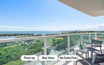 a balcony with two chairs and a view of the ocean at MVR-Bask in Luxury-Right in Coconut Grove in Miami