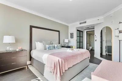 a bedroom with a large bed with a pink blanket at MVR-Bask in Luxury-Right in Coconut Grove in Miami