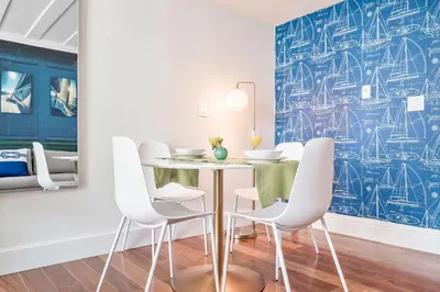 a dining room with a table and white chairs at MVR-See the City Sparkle-Every Night in Miami