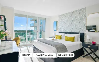 a bedroom with a king sized bed and a balcony at MVR-Your Gateway to Miami-s Culture & Calm in Miami