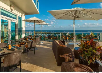 a patio with chairs and tables and umbrellas at MVR-Your Escape Your View Your Grove in Miami