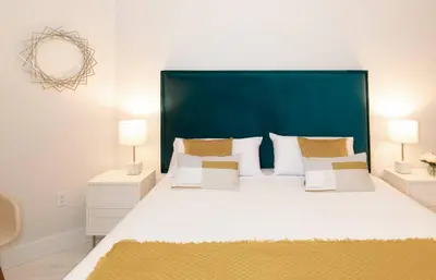 a bedroom with a large bed with a blue headboard at MVR-Wake Up to Biscayne Bay Views Every Morning in Miami