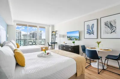 a hotel room with two beds and a table and chairs at MVR - Experience Coconut Grove Without Compromise in Miami