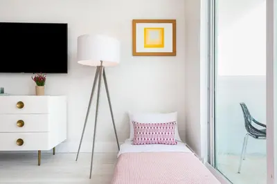 a room with a lamp and a pillow and a tv at MVR - Experience Life Above the Miami Skyline in Miami