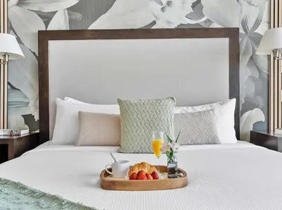a tray with fruit and drinks on a bed at MVR - Where Style Comfort and Convenience Meet in Miami