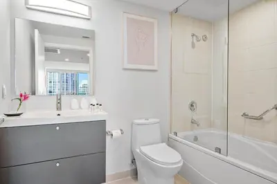 a bathroom with a toilet and a tub and a sink at MVR - The Best of Work Relaxation in One in Miami
