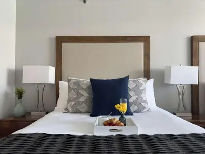 a bed with a tray with a drink and fruit on it at MVR-Modern Touches Coconut Grove Warmth in Miami