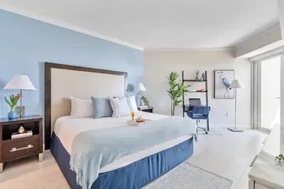 a bedroom with a large bed with blue walls at MVR - Sunsets So Good You-ll Book Twice in Miami