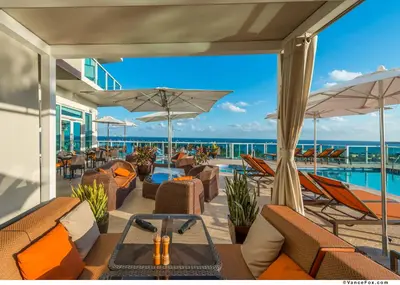 a resort patio with chairs and a swimming pool at MVR - Ideal for Business & Weekend Trips in Miami