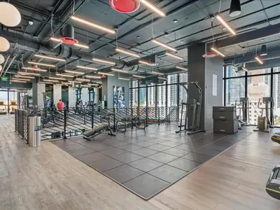 a gym with rows of exercise equipment in a building at MVR - If You Want the Best Views Stay Here in Miami