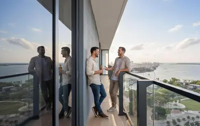 a group of men standing on the balcony of a building at MVR - If You Want the Best Views Stay Here in Miami