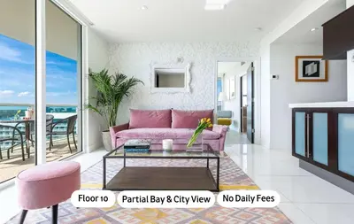 a living room with a pink couch and a table at MVR-Stop Searching-This Stay Has It All in Miami