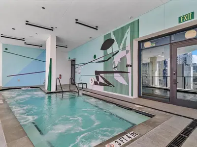 a swimming pool in a building with a mural at MVR - Walkable Downtown Gem with Breathtaking Views in Miami