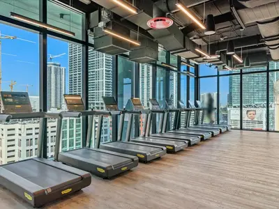 a gym with a row of beds in a room with windows at MVR - Walkable Downtown Gem with Breathtaking Views in Miami