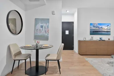 a dining room with a table and chairs and a kitchen at MVR - Walkable Downtown Gem with Breathtaking Views in Miami