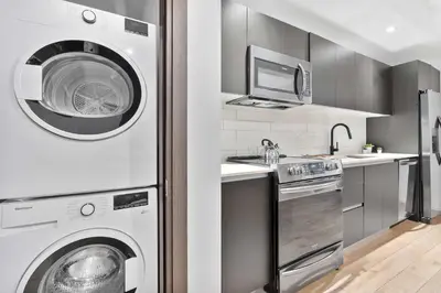 a kitchen with a washing machine and a washer at MVR - Sunset & Skyline Magic from Your Balcony in Miami