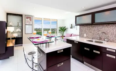 a kitchen with a sink and a counter with glasses of wine at MVR - Miami's Most Exclusive Stay-Revealed in Miami