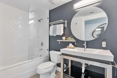 a bathroom with a sink and a toilet and a mirror at MVR - Rooftop Access Rooms-Almost Gone in Miami