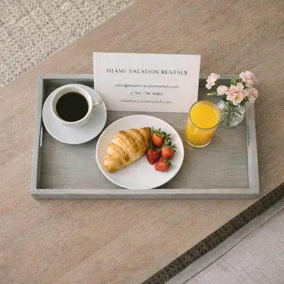 a tray with a breakfast plate with a cup of coffee and strawberries at MVR - Stop Searching-This Grove Stay Has It All in Miami