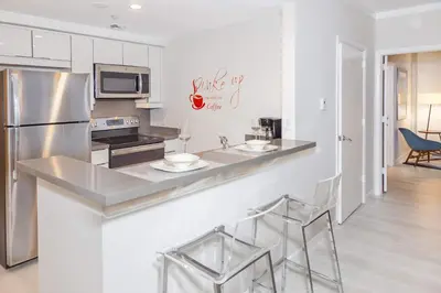 a kitchen with a counter and a refrigerator at MVR - Miami-s Most Exclusive Stay-Revealed in Miami