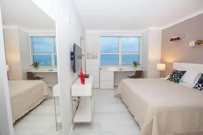 a bedroom with two beds and a sink and two windows at MVR - Miami-s Most Exclusive Stay-Revealed in Miami