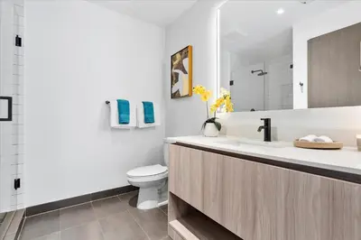 a white bathroom with a sink and a toilet at MVR - Swim Relax & Enjoy Jaw-Dropping Views in Miami
