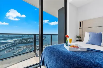 a bedroom with a bed and a large window at MVR - Swim Relax & Enjoy Jaw-Dropping Views in Miami