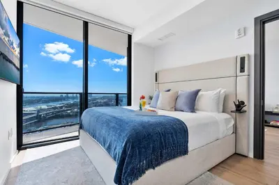 a bedroom with a large bed with a large window at MVR - Swim Relax & Enjoy Jaw-Dropping Views in Miami