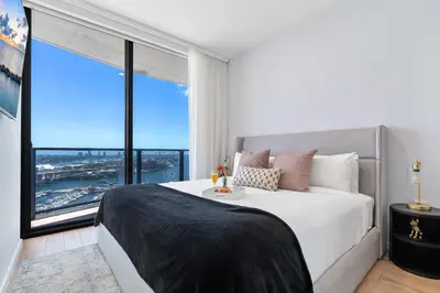 a bedroom with a large bed with a large window at MVR - Designer Apt with Jaw-Dropping Views & Pool in Miami
