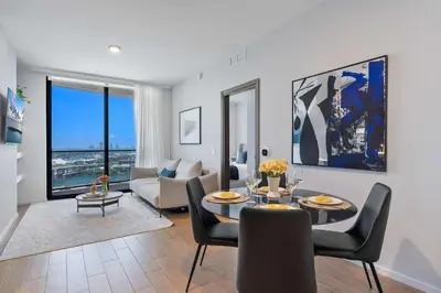 a living room with a table and chairs and a couch at MVR - Designer Apt with Jaw-Dropping Views & Pool in Miami