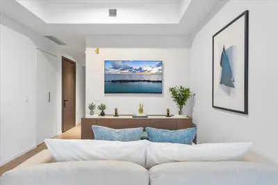 a living room with a white couch and blue pillows at MVR - Only for VIP Travelers - Luxe Stay in Downtown in Miami