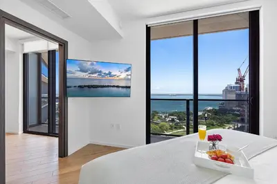 a white room with a table with a bowl of fruit at MVR - Miami-s #1 Rated 1BR - Sup3rhost Approved in Miami