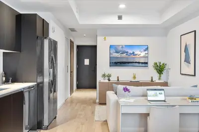 a kitchen and living room with a laptop on a table at MVR - Miami-s #1 Rated 1BR - Sup3rhost Approved in Miami