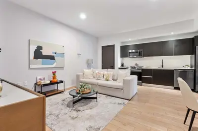 a living room with a white couch and a kitchen at MVR - SupErhost Stay 10 Yrs of 5-Star Service in Miami