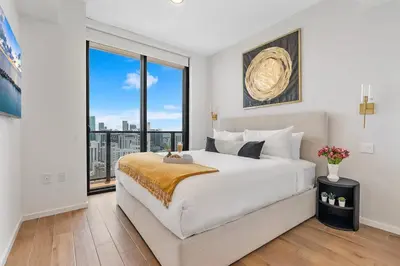 a bedroom with a large bed and a large window at MVR - VIP Pool Deck & Rooftop Lounge Access in Miami