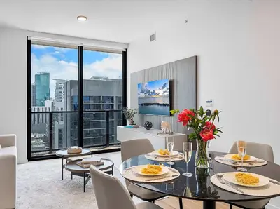 a dining room with tables and chairs and a large window at MVR - Wake Up to Miami-s Most Iconic Views in Miami