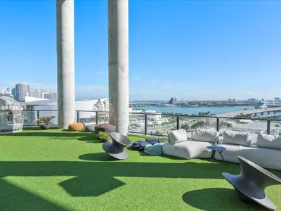 a patio with couches and chairs on top of a building at MVR - Wake Up to Miami-s Most Iconic Views in Miami
