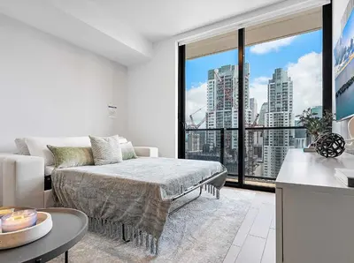 a living room with a bed and a large window at MVR - Wake Up to Miami-s Most Iconic Views in Miami