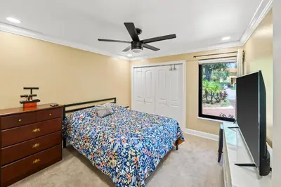 a bedroom with a bed and a flat screen tv at Luxury Queen Room, Walk to UM, Free Car Service! in Miami