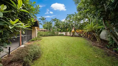a yard of a house with green grass and trees at Luxury Queen Room, Free Car Service, Walk to UM! in Miami