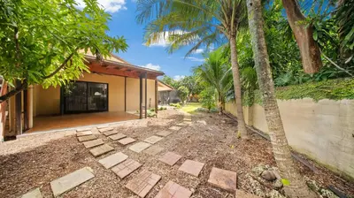 a walkway in front of a house with palm trees at Luxury Queen Room, Free Car Service, Walk to UM! in Miami