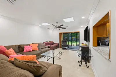 a living room with a couch and a table at Large Private Room, Free Car Service, Walk to UM! in Miami