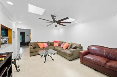 a living room with two couches and a ceiling fan at Large Private Room, Free Car Service, Walk to UM! in Miami