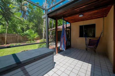 a screened porch with a hammock and a flag at Large Private Room, Free Car Service, Walk to UM! in Miami
