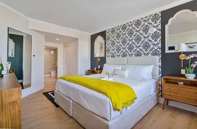a bedroom with a large bed with a yellow blanket at MVR Relax in Suite with Biscayne Bay Sunsets in Miami