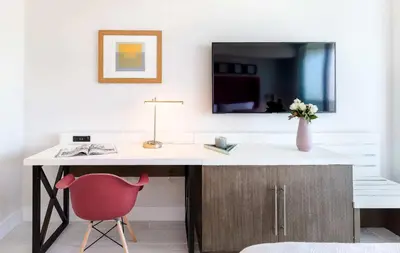 a desk with a red chair and a mirror at MVR Suite-A Stay That Feels Like a Private Resort in Miami